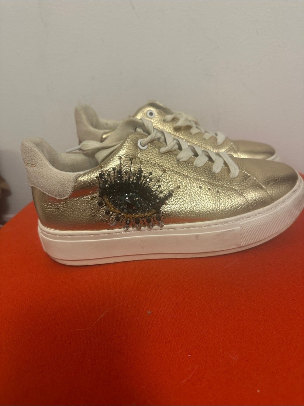 Kurt Geiger Gold Platform Sneaker with Embellished Eye Accent
